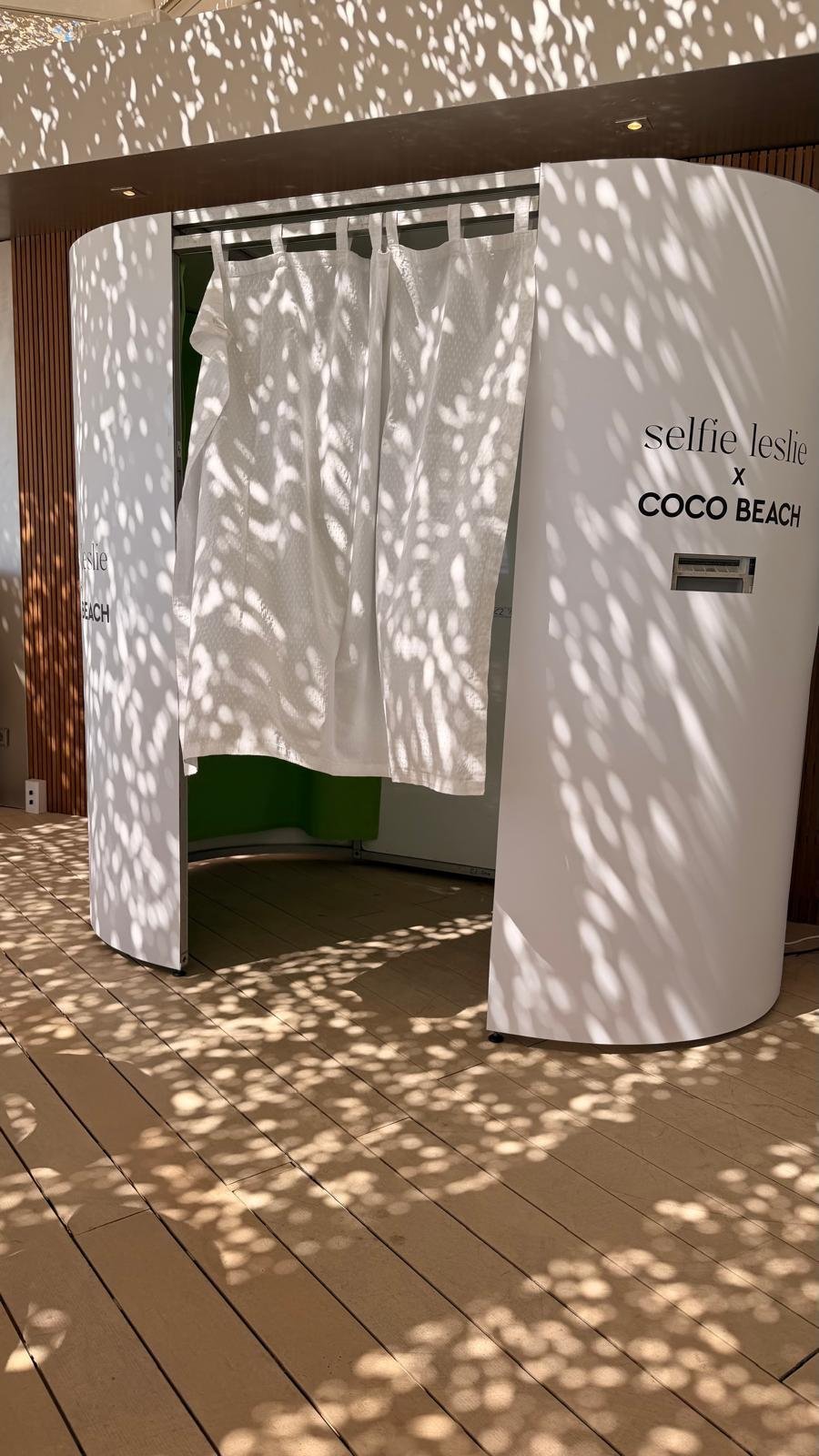 Open white photo booth with curtain drawn at Coco Beach Ibiza